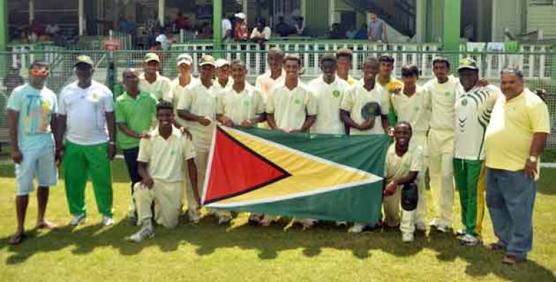 West Indies middle order batsman Shivnarine Chanderpaul (extreme left) and Guyana Cricket Board president Drubahadur (right) join the national Under-19 team and their coach, who proudly display the Golden Arrowhead, following their innings victory over Trinidad and Tobago yesterday.