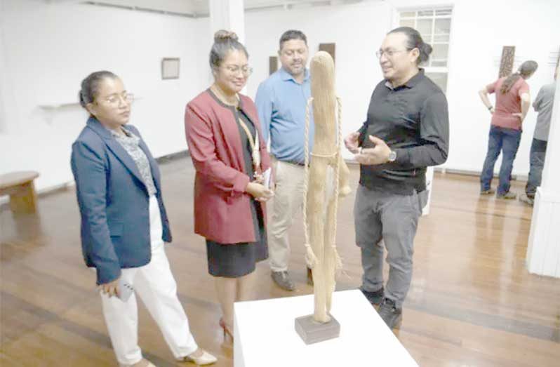 The Minister of Amerindian Affairs, Sarah Browne, engaging with young artist’s part of the Art Exhibition at the Casellani House