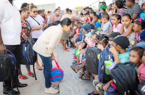 Approximately 500 children from Better Hope and Tiger Bay collected back-to-school backpacks from First Lady Arya Ali