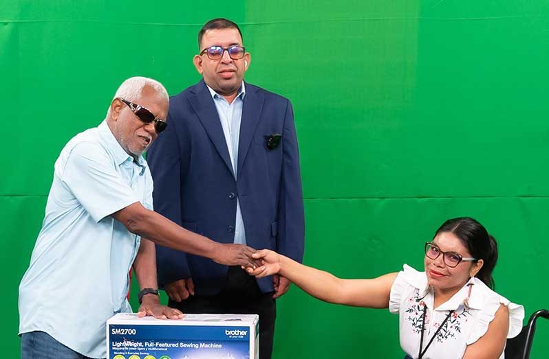 From left: Chairman of GCOPD, Cecil Morris; Programme Manager at GCOPD, Ganesh Singh and Ashinee Abrams, during the presentation ceremony on Wednesday (Delano Williams photo)