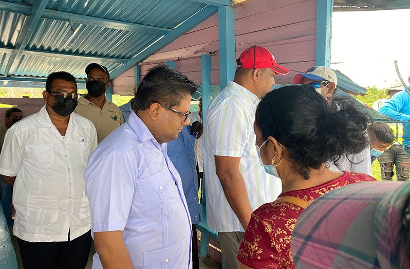 Senior Minister with Responsibility for Finance within the Office of the President, Dr. Ashni Singh listens to the concern of a resident