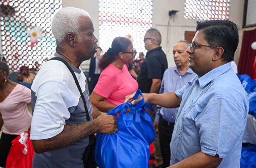 Senior Minister in the Office of the President with Responsibility for Finance, and the Public Service, Ashni Singh distributing Christmas Hampers at the Salvation Army’s distribution