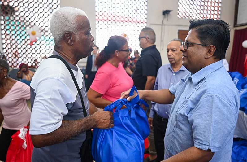 Senior Minister in the Office of the President with Responsibility for Finance, and the Public Service, Ashni Singh distributing Christmas Hampers at the Salvation Army’s distribution