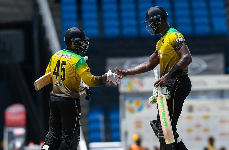 Asif Ali (L) and Carlos Brathwaite (R) of Jamaica Tallawahs celebrate winning the Hero CPL match 3 against St Lucia Zouks at Brian Lara Cricket Academy yesterday in Tarouba, Trinidad and Tobago. (Photo by Randy Brooks - CPL T20/CPL T20 via Getty Images)