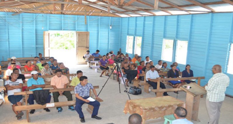 Minister within the Ministry of Finance, Bishop Juan Edghill, addressing residents at Assakata