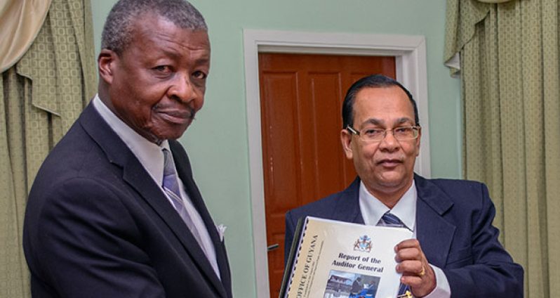 The Speaker of the National Assembly,Dr Barton Scotland, is seen receiving the 2015 Report on the Public Accounts from Auditor General Deodat Sharma (Samuel Maughn photo)
