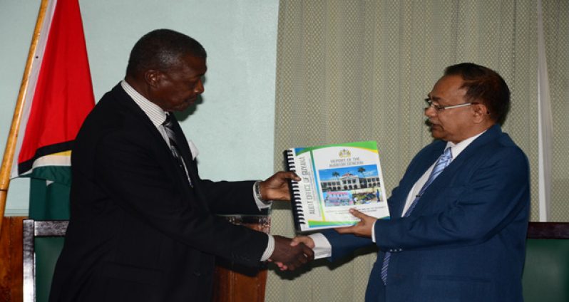 Speaker of the National Assembly Dr. Barton Scotland (left) receives the Audit Report for 2014 from Auditor-General Deodat Sharma at the Public Buildings (Photo by Adrian Narine)