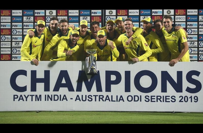 The victorious Australian team poses with the trophy after winning the series. (Getty Images)