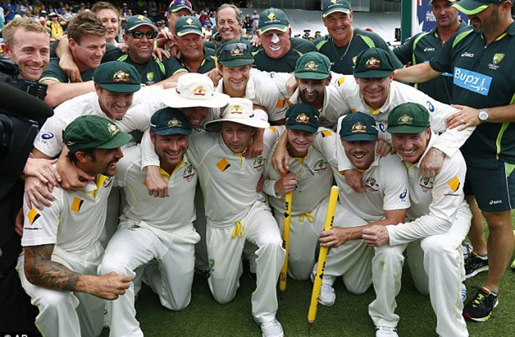 Winning feeling: The Australia team and staff celebrate their well-deserved Ashes victory over England at the Gabba.