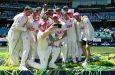 Australia pose with the Ashes trophy after sealing a 4-1 series win • (AFP/Getty Images)
