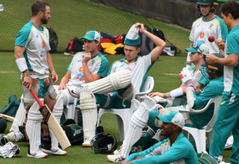 Relaxed: Australia's Marnus Labuschagne pulls off his headgear as his teammates take a break during training at the Melbourne Cricket Ground on Thursday.