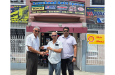 Ramchand Ragbeer (centre) of Ramchand Auto Spares presents the sponsorship to Davteerth Anandjit in the presence of Anil Beharry