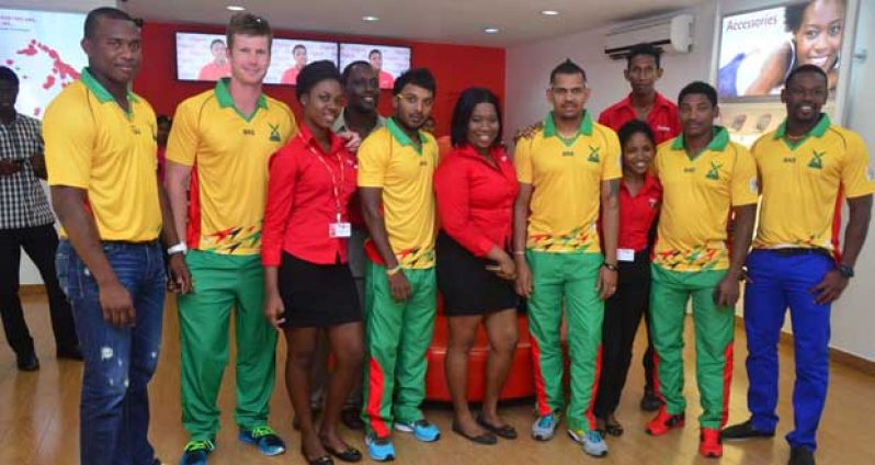 Calling all Warriors! From left, Christopher Barnwell, James Neesham, Veerasammy Permaul, Sunil Narine, Krishmar Santokie and Navin Stewart, strike a pose with Digicel’s Sponsorship and Events Manager Gavin Hope (partly hidden 4th from left) and staff of Digicel’s Avenue of the Republic outlet. (Photo by Adrian Narine)