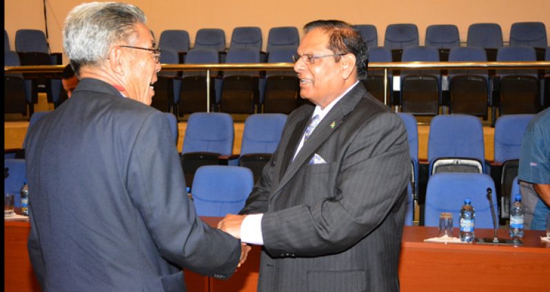 Prime Minister Moses Nagamootoo greats aviation pioneer Paul Chan-A-Sue at the opening of an aviation conference