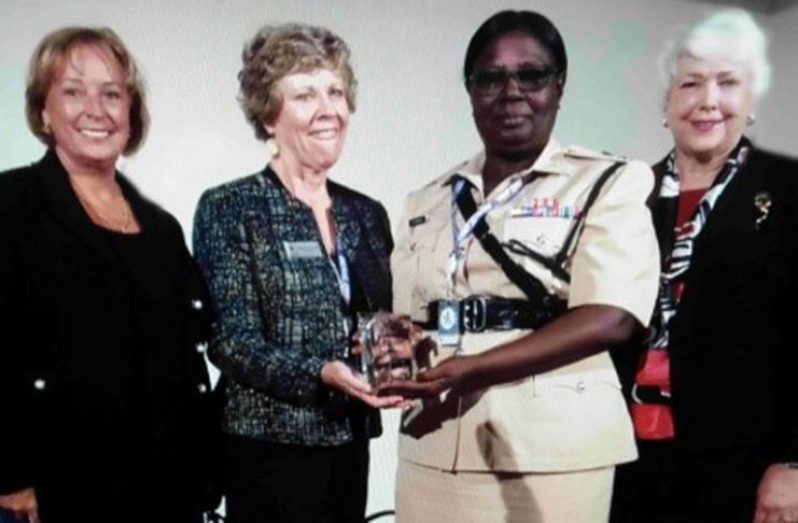 Senior Superintendent Maxine Graham, DSM, receives her award from Madam President of the International Association of Women Police, Margaret Shorter, in Barcelona, Spain