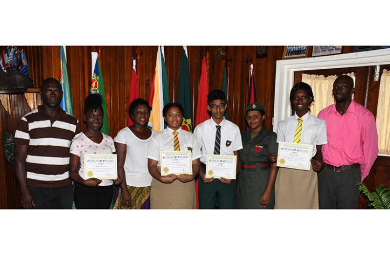 The four students, in the presence of their parents, display their awards for Academic Excellence at Defence Headquarters
