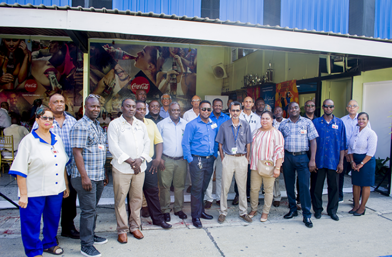 Company officials with the long-standing employees who were honoured on Friday