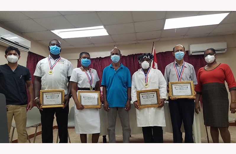 The awardees, along with Doctor In Charge Dr Sukhdeo, Administrator Shaneeza Nabi and RHTYSC’s Ravindranauth Kissoonlall, after the presentation.