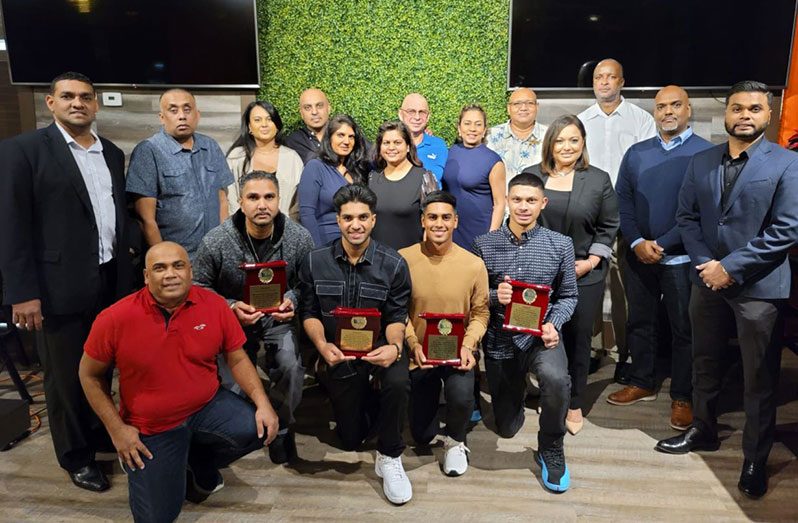 The awardees: Surendra Seeraj, Arjuna Sukhu, Ethan Gibson and Matthew Nandu pose with SCA executives and their parents