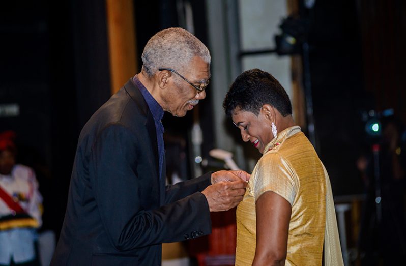 Baidwantie Balgobin being conferred with the Medal of Service by President Granger (Delano Williams photo)