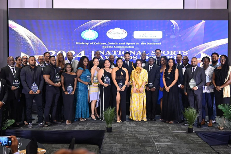The awardees alongside Ministers Charles Ramson Jr. and Steven Jacobs at the Pegasus Hotel on Saturday evening