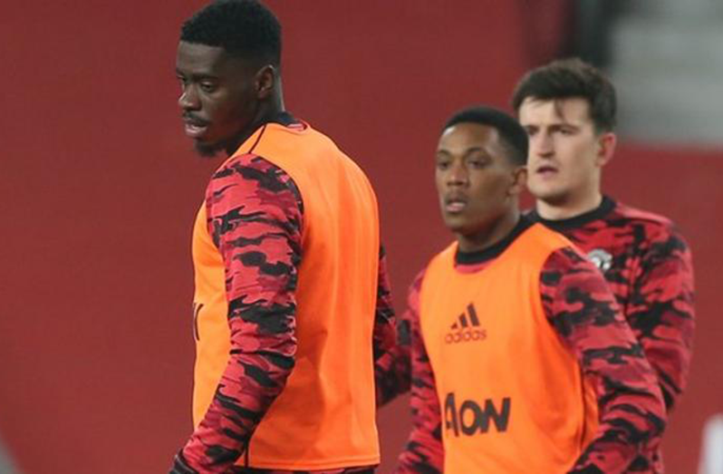Axel Tuanzebe and Anthony Martial pictured warming up before Wednesday's game with captain Harry Maguire