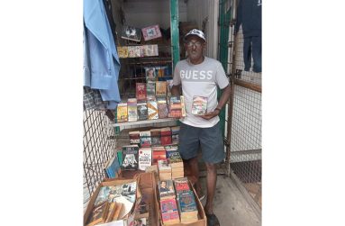 Ayube Khan displays his books at his stall in Vendor’s Arcade