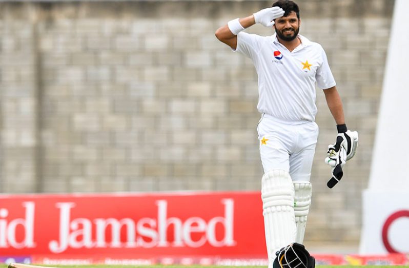 Azhar Ali salutes after reaching  his 13th Test century on the third day of the Bridgetown Test.