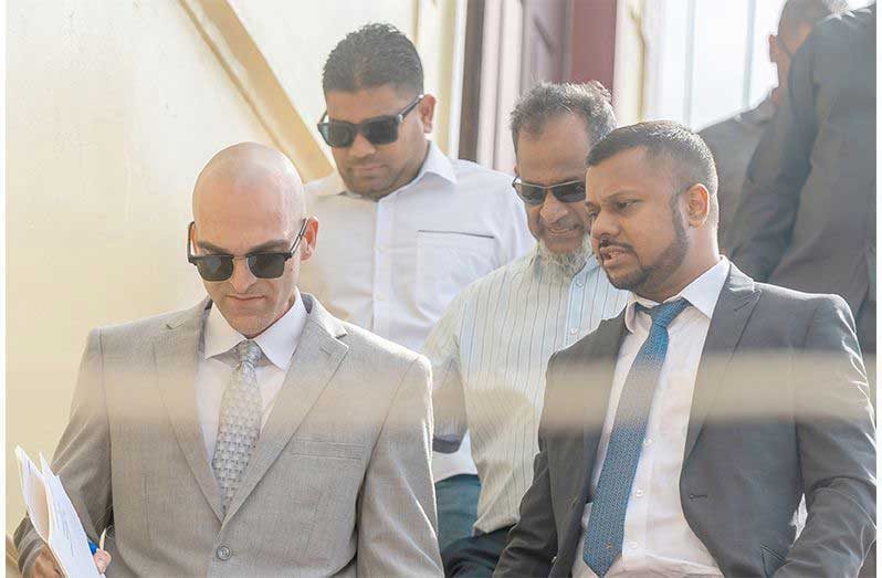 Nazar Mohamed and  his son Azruddin, accompanied by their  attorneys, Siand Dhurjon and Damien DaSilva at the Georgetown Magistrates’ Courts