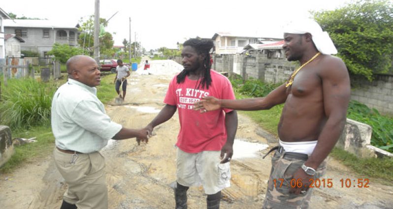 Newly-appointed community coordinator, Mr. Neilson McKenzie (left) interacting with residents of ‘B’ Field, Sophia