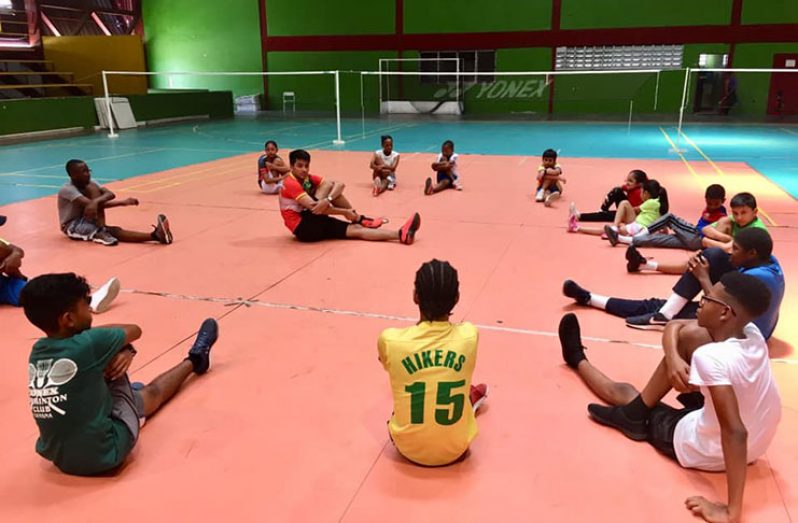 National player Narayan Ramdhani (centre) takes some participants through their paces at last year’s camp.
