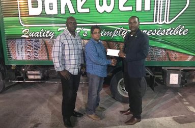 Bakewell’s Rajendranaught Ganga makes the presentation to GFF’s president Wayne Forde. Also in photo is Aubrey ‘Shanghai’ Major.