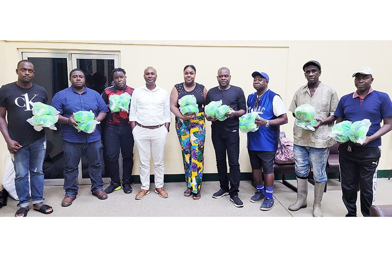 GFF president Wayne Forde (fourth left) distributed balls to UDFA Clubs
