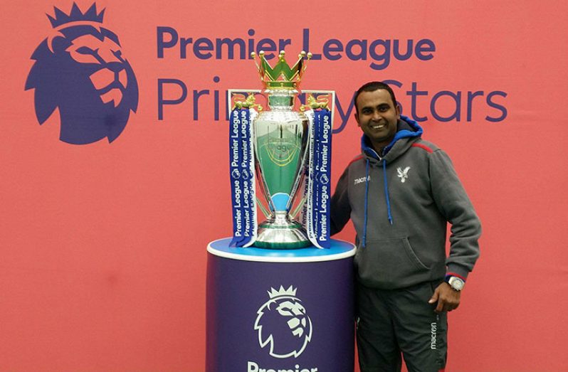Peter Barry with the premiership trophy at a Girls’ Football Festival.