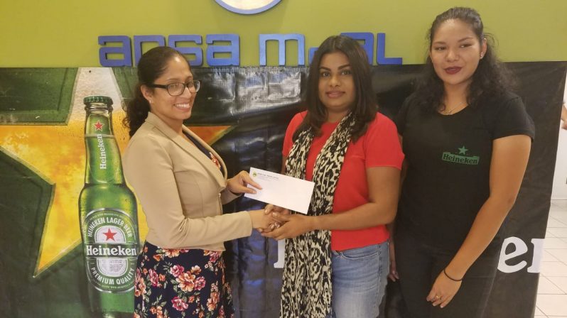 Darshanie Yussuf, Business Unit head, Ansa McAl Trading Limited (2nd right) hands over cheque to Bartica Easter Regatta Committee secretary Ms Cianna Persaud in the presence of Heineken Brand coordinator.