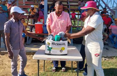 BCB president, Hilbert Foster, hands over bowling machine to Roshan Gaffoor of Cotton Tree