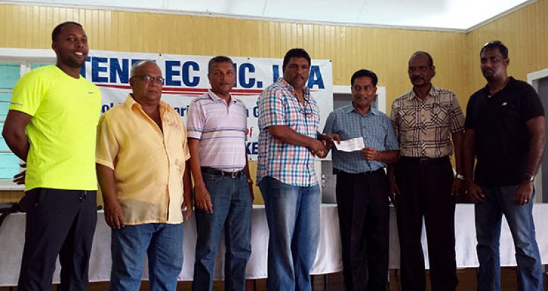 Bobby Deonarine (third right) hands over the sponsorship cheque to Anil Beharry, president of the BCB, in the presence of other board members and representatives of the GCB.