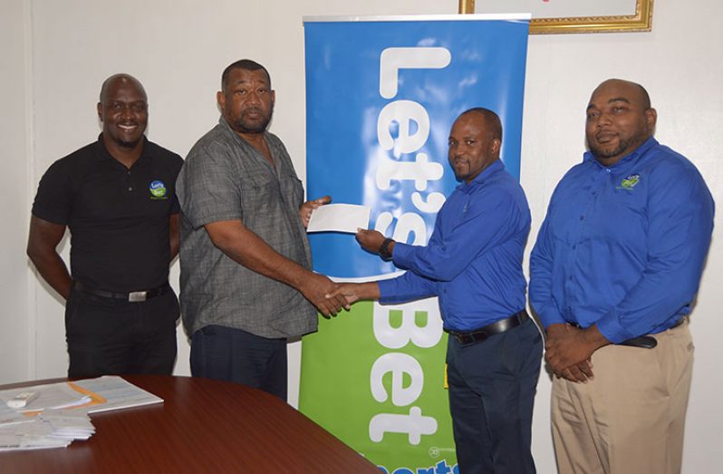 Let’s Bet Sports Brand Manager, Ian De Barros, (2nd right) hands over the sponsorship cheque to BCB president Hilbert Foster at the launch of the tournament in May, while Brand Ambassador Rawle Toney (left) and Assistant Brand Manager, Joel Lee look on.