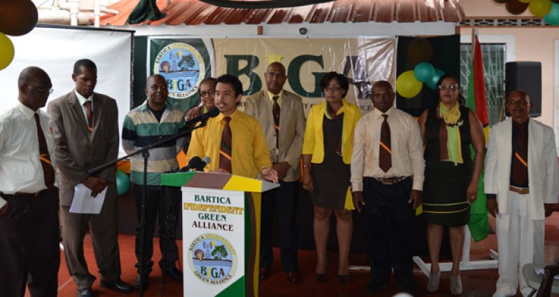 Standing at the podium is Chairperson Allon Fernandes flanked by nine of the BIGA constituent representatives.