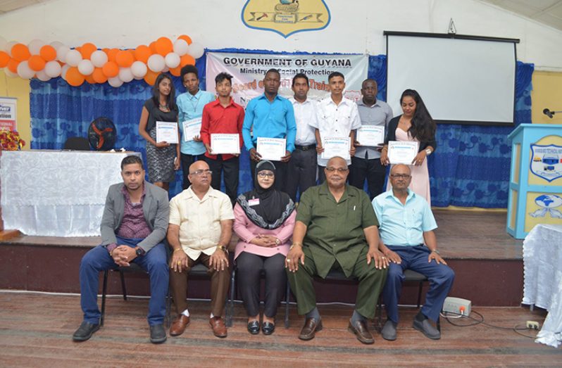 Officials from the Board of Industrial Training, the Essequibo Technical Institute, along with REO Denis Jaikarran [seated second left] and BIT Vice-Chairman, Donald Ainsworth [seated second right] along with some of the graduates
