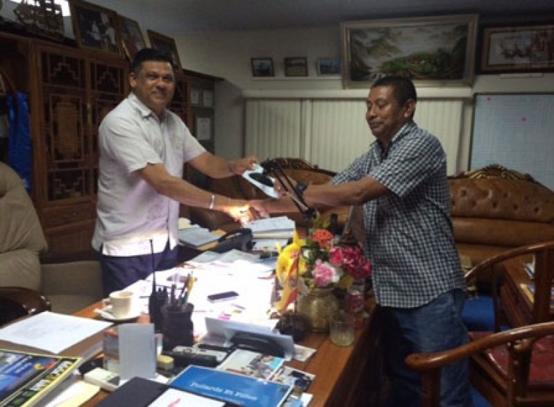 Brian Tiwari hands over cheque to GVF president John Flores