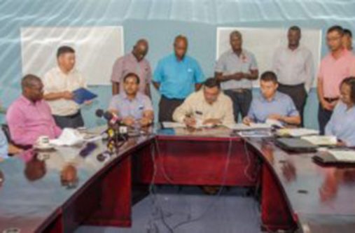 Owner of BK International Incorporated, Brian Tiwari, inking the agreement with China Harbour Engineering Company for the purchase of stones for the Cheddi Jagan International Airport (CJIA) expansion project