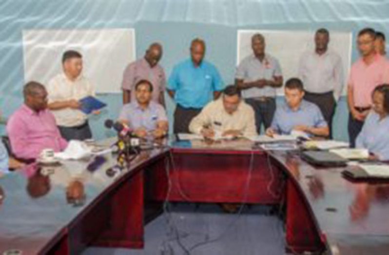 Owner of BK International Incorporated, Brian Tiwari, inking the agreement with China Harbour Engineering Company for the purchase of stones for the Cheddi Jagan International Airport (CJIA) expansion project