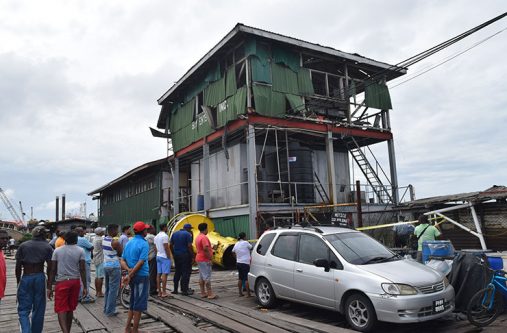A crowd gathered outside the scene of the incident. Carlton Meghan was working at the top floor of the zinc covered building at the time of the incident. He was flung off of the platform following the explosion. (Cullen-Bess Nelson photo)