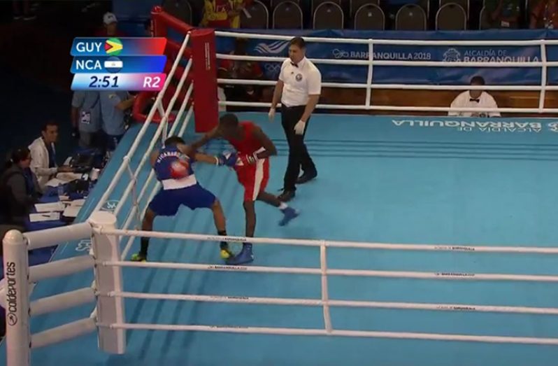 Guyanese boxer Colin ‘Superman’ Lewis (red) lands a punch on his Nicaraguan opponent Onealdt Mayorga during their light welterweight (64kg) bout.