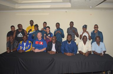 GBA president Steve Ninvalle (fourth from right) and Director of Sport Christopher Jones (third from left) are flanked by fighters, coaches and managers for the participating teams of the Caribbean Boxing Championship. The Championship opens tonight at the Cliff Anderson Sports Hall. (Samuel Maughn photo)