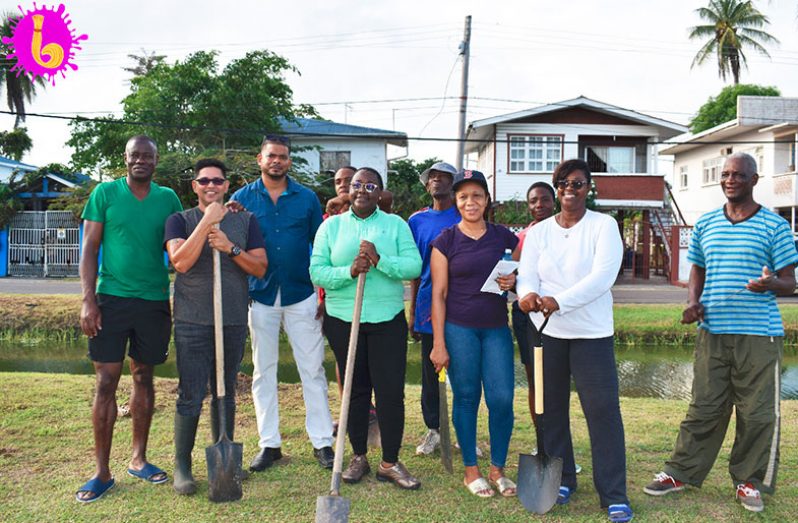 Junior Minister of Natural Resources Simona Broomes, (centre), stands along with other residents of the community after the tree- planting initiative.