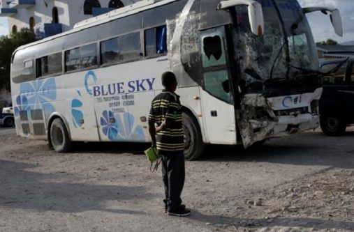 A man looks at a bus, which drove into a parade of pedestrians, parked in the police station of Gonaives, Haiti, March 12, 2017. REUTERS/Andres Martinez Casares