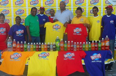 General Manager of Guyana Beverage Company Robert Selman (green top) hands over T-shirts to RHTYSC Secretary/CEO Hilbert Foster, while Marketing Manager Shameiza Yadram and other staff members proudly display others.