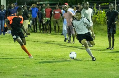 A BV/Buxton player trying to make his way around his East Ruimveldt opponent during their match at the Buxton Community Centre ground (Photo compliments: DPI)